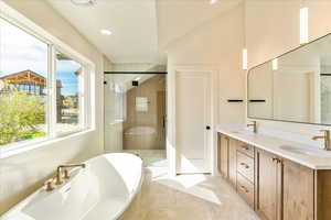 Full bathroom featuring double vanity, a soaking tub, a stall shower, light tile patterned floors, and recessed lighting