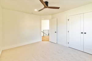 Unfurnished bedroom with light carpet, ceiling fan, and recessed lighting