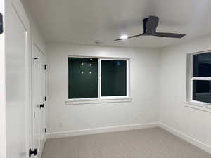 Spare room with light colored carpet and ceiling fan