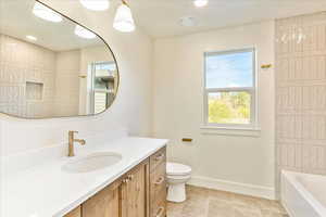 Bathroom featuring vanity, bathtub / shower combination, and recessed lighting