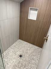 Full bath featuring tiled shower