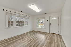 Foyer with baseboards and light wood-style floors