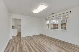 Empty room featuring light wood-style flooring and baseboards