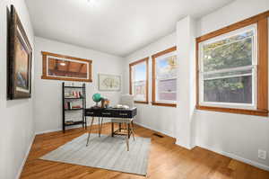 Home office featuring light wood-style floors