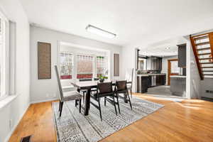 Dining space with light wood-type flooring and baseboards