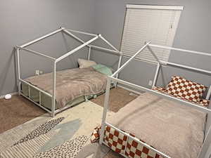 Carpeted bedroom featuring baseboards