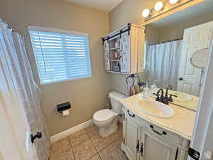 Full bath with vanity, a shower with curtain, and light tile patterned floors