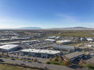 Aerial view of industrial structures and a mountain backdrop