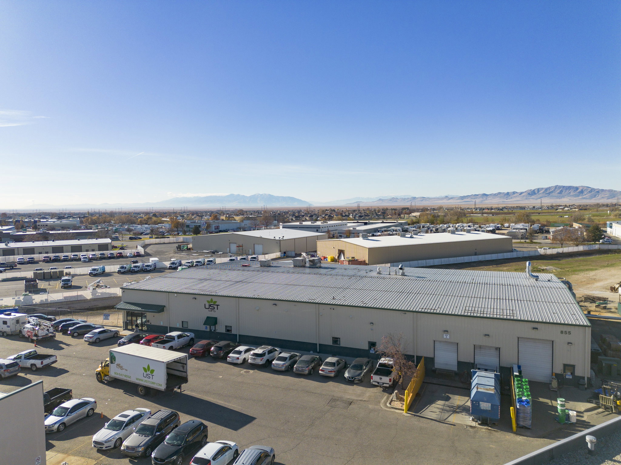 Drone / aerial view of a mountain backdrop and industrial structures