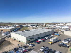 Bird's eye view of industrial structures and a mountain backdrop