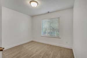 Carpeted spare room featuring baseboards and a textured ceiling