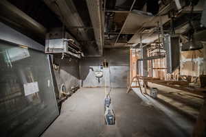 Unfinished below grade area with a heating unit