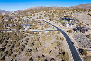 Aerial overview of property's location featuring a mountainous background and nearby suburban area