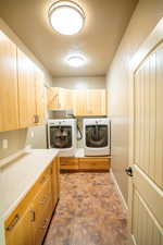 Laundry room featuring cabinet space and washing machine and clothes dryer