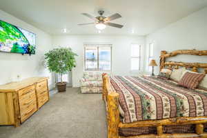 Bedroom featuring light carpet and ceiling fan