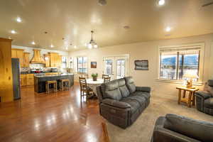 Living room with french doors, recessed lighting, and dark wood-style flooring