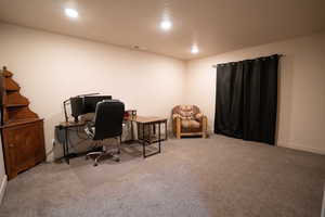 Carpeted office with recessed lighting and baseboards