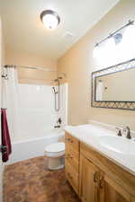 Full bathroom featuring shower / bath combo with shower curtain and vanity