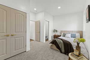 Bedroom featuring carpet, ensuite bathroom, recessed lighting, and a closet