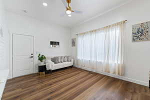Sitting room featuring dark wood finished floors, plenty of natural light, a ceiling fan, and recessed lighting
