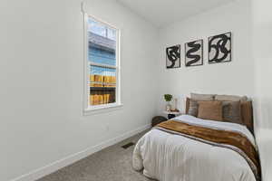 Bedroom featuring carpet flooring and baseboards