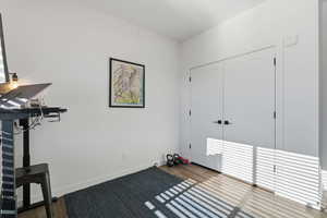 Unfurnished bedroom featuring wood finished floors and a closet
