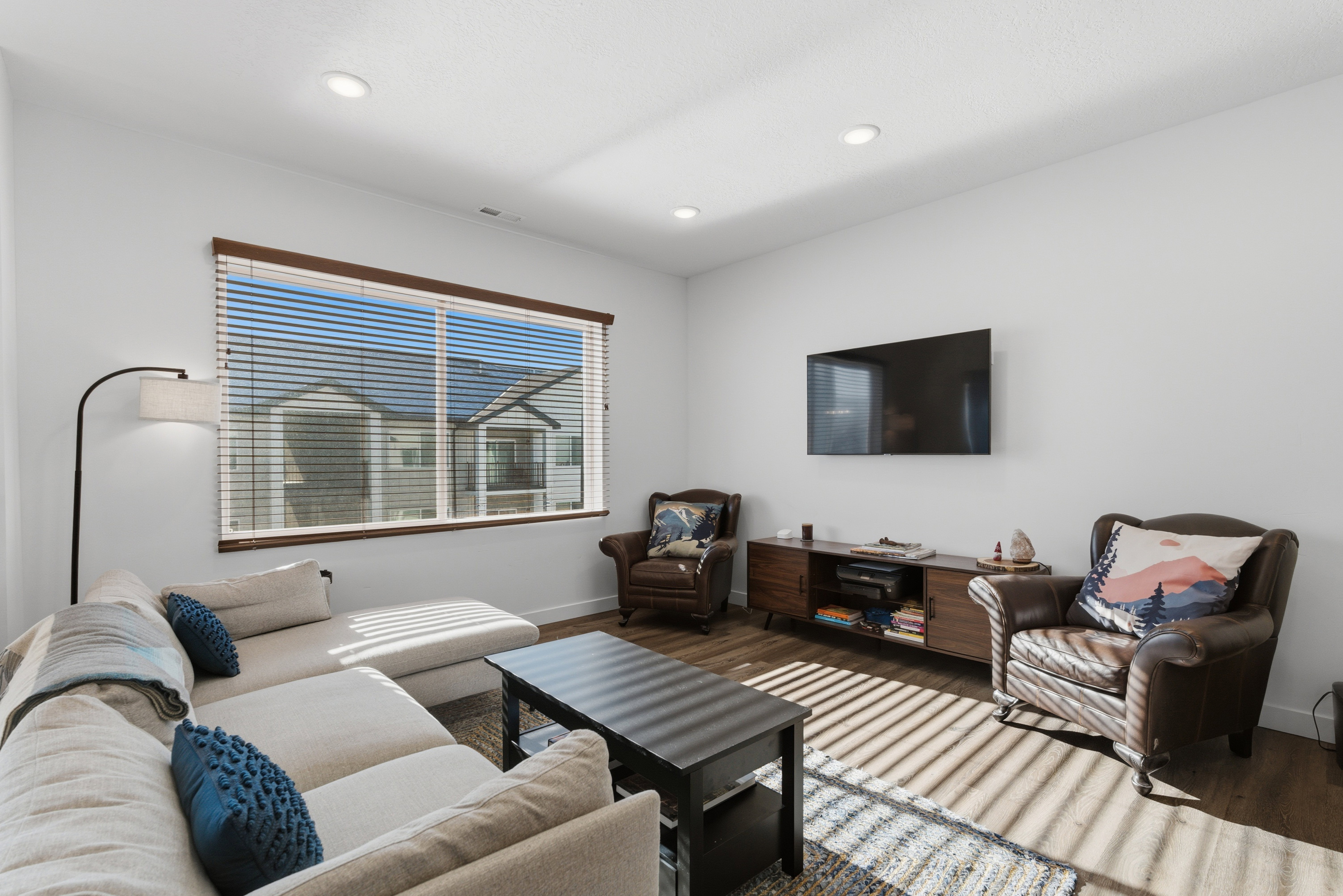 Living area featuring wood finished floors and recessed lighting