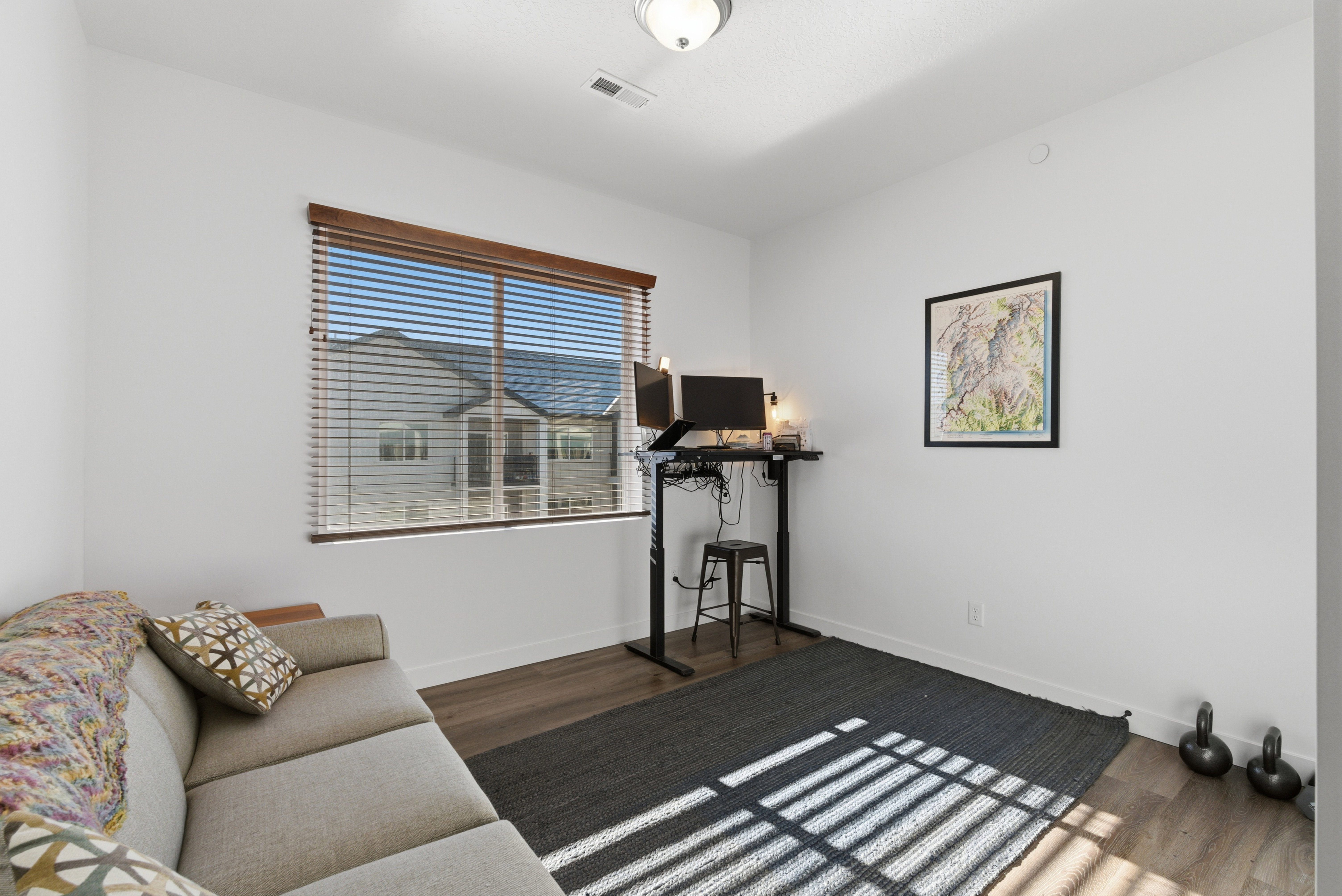 Workout area featuring dark wood-style flooring and baseboards