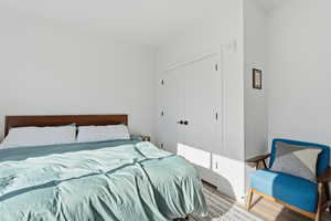 Bedroom with a closet and wood finished floors