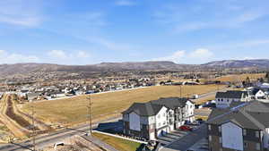 Aerial view of residential area featuring a mountainous background