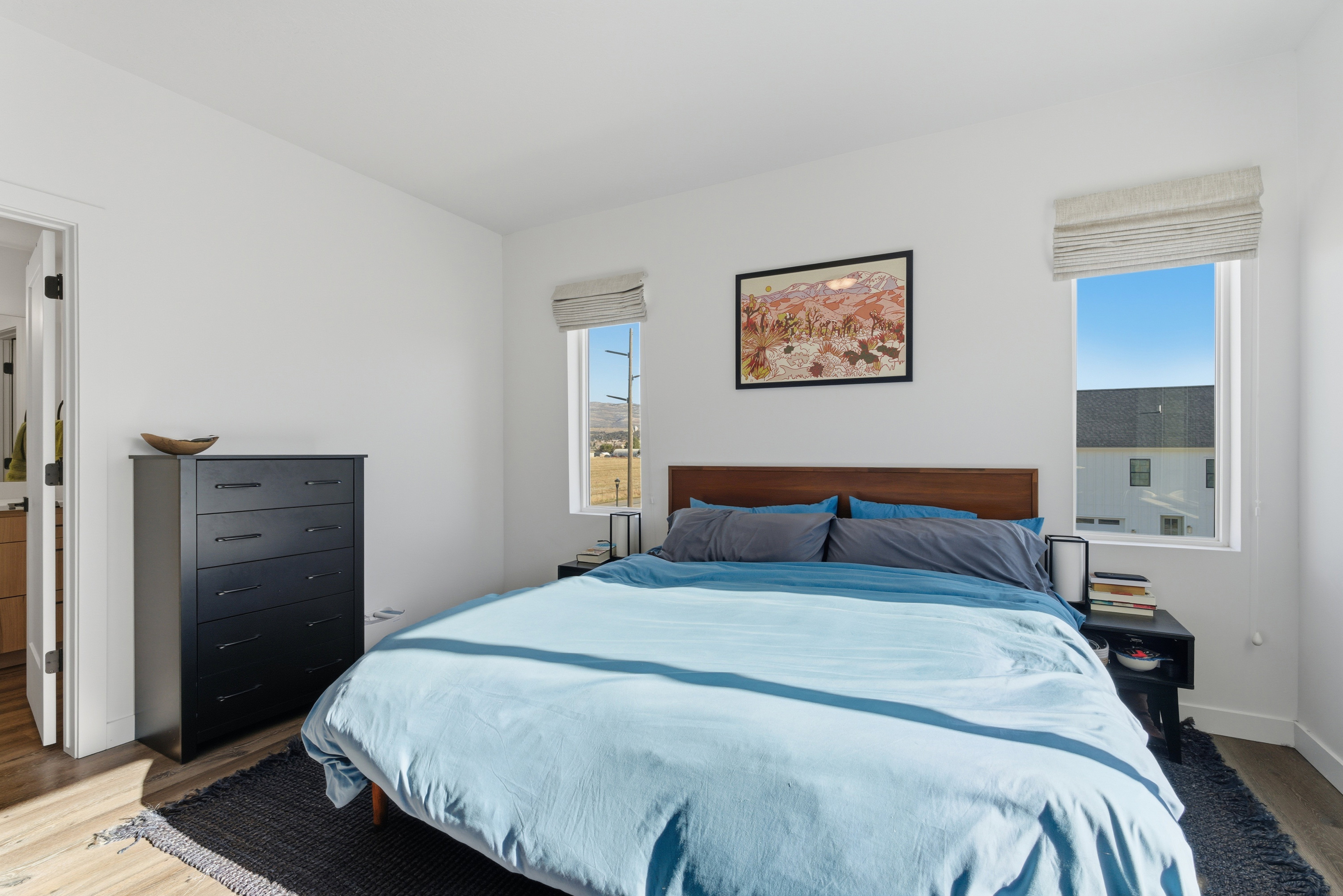 Bedroom with wood finished floors and baseboards