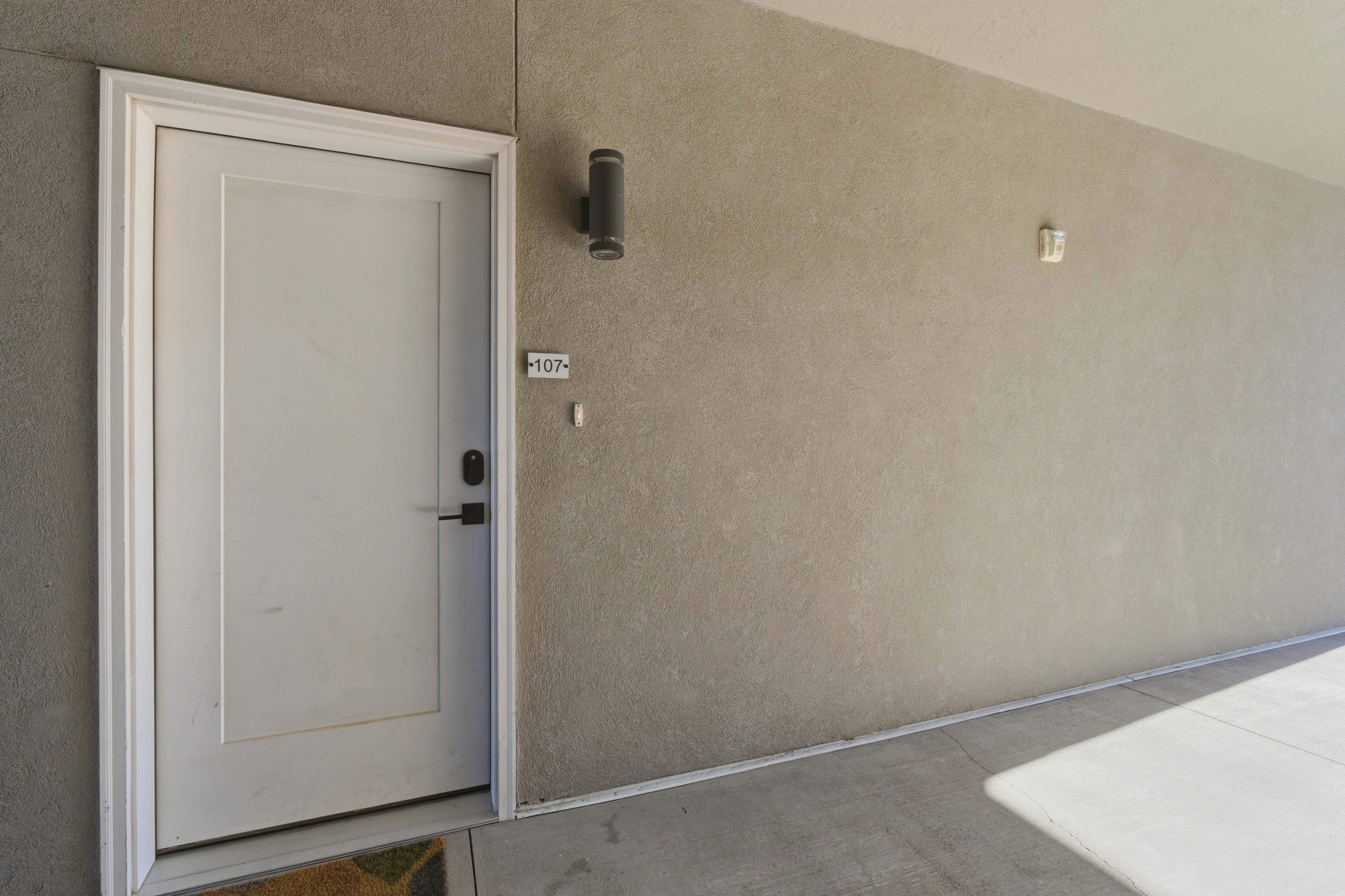 3RD FLOOR UNIT. Doorway to property featuring stucco siding