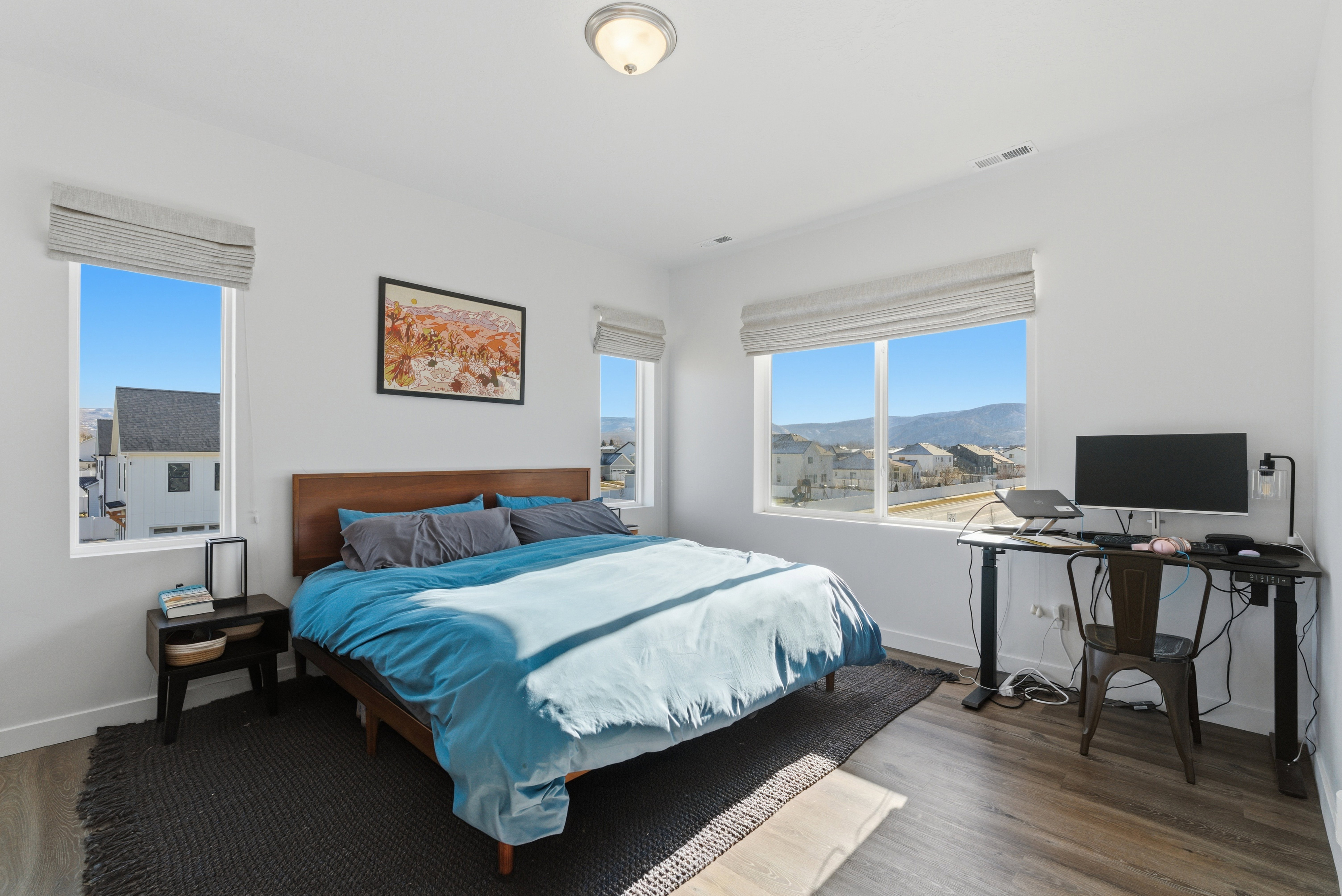 Bedroom with an office area and wood finished floors