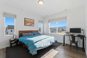Bedroom with an office area and wood finished floors