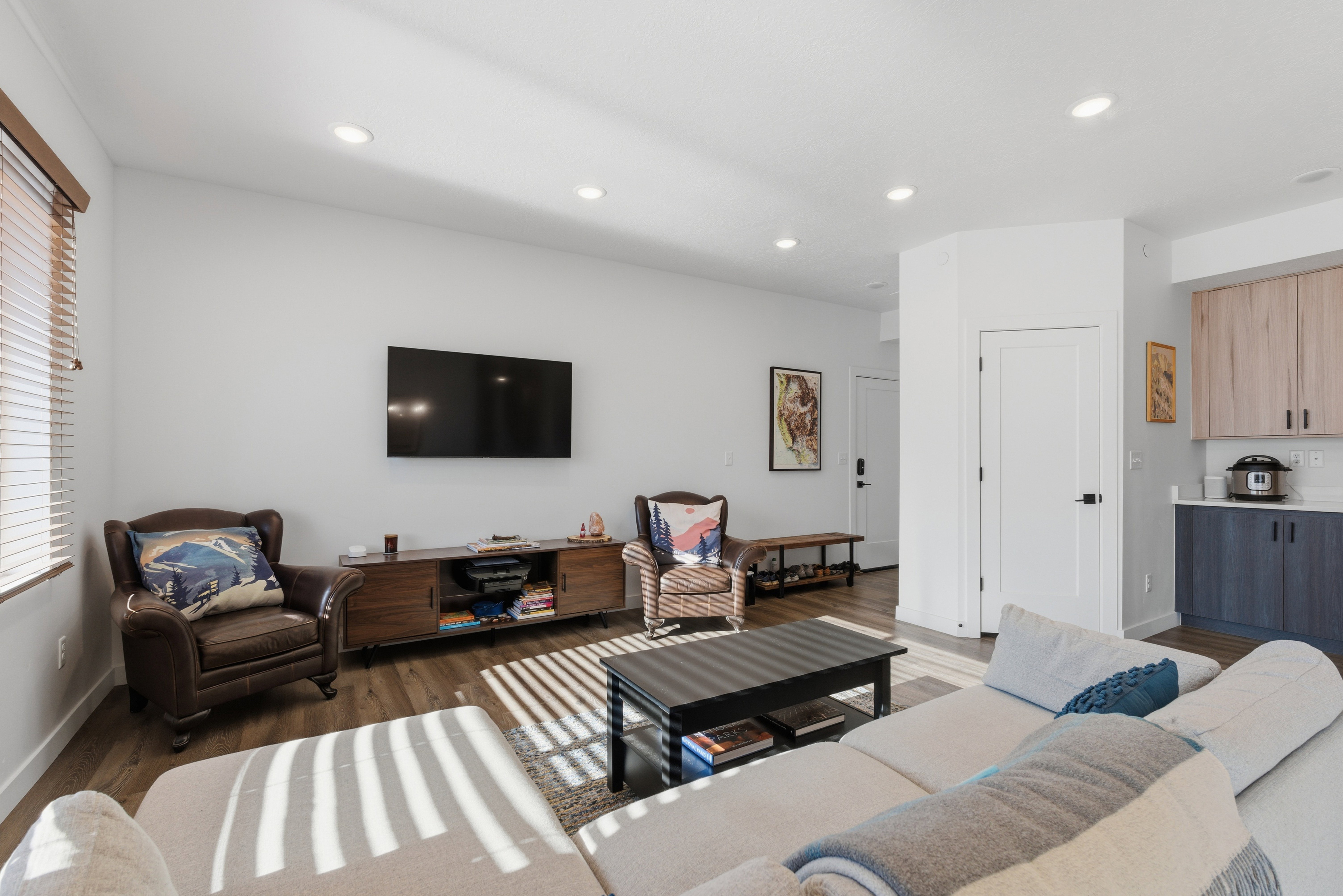Living area featuring dark wood finished floors and recessed lighting