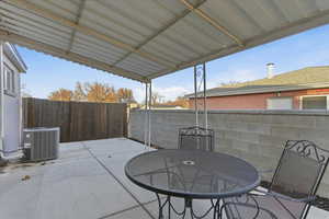 Fenced backyard with a patio and outdoor dining area