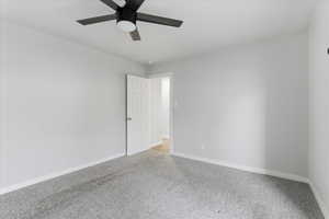 Spare room with carpet floors and ceiling fan
