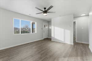 Empty room featuring light wood-style floors and ceiling fan