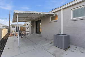 Fenced backyard featuring a patio area, a pergola, outdoor dining space, entry steps, and a shed