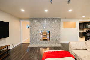 Living area featuring dark wood-style floors and recessed lighting