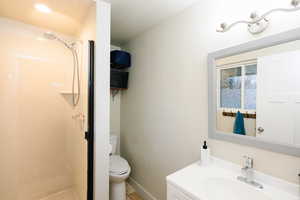 Full bath featuring vanity, a shower stall, and light tile patterned floors