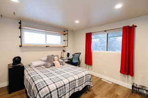 Bedroom featuring wood finished floors, recessed lighting, and multiple windows