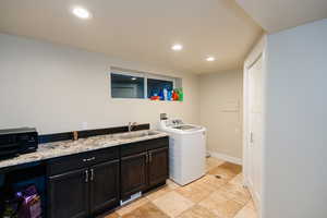 Laundry area featuring washer / clothes dryer, recessed lighting, and cabinet space