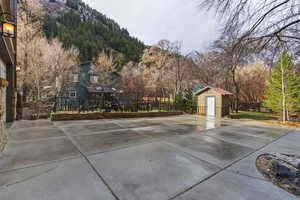 View of patio with a storage shed and a mountain view