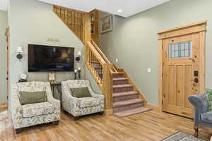 Entryway featuring stairs, wood finished floors, and recessed lighting