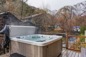 Deck featuring a mountain view and a hot tub