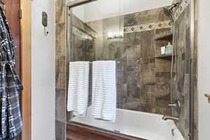 Full bathroom with enclosed tub / shower combo