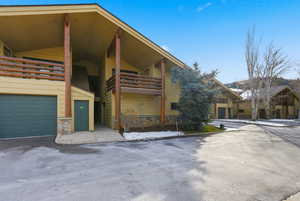 View of front of home featuring stone siding and a garage