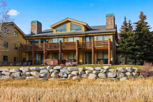 Rear view of house with a chimney and a patio