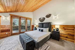 Bedroom with wood ceiling, access to outside, carpet, lofted ceiling, and wood walls